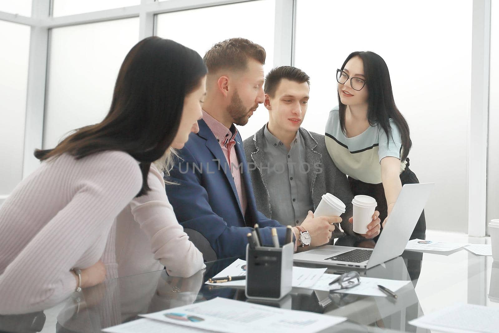 Manager pointing to laptop screen during working meeting . people and technology