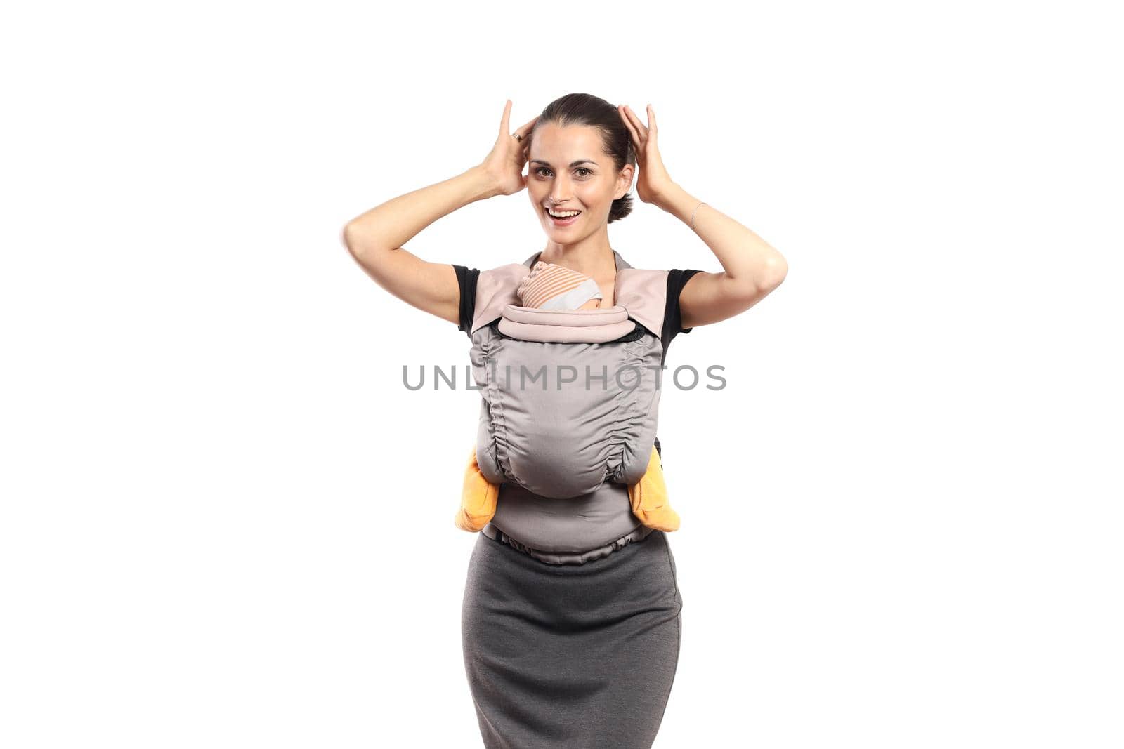 Babywearing beautiful young mother with baby in carrier, isolated on white. Free hands and active motherhood concept.