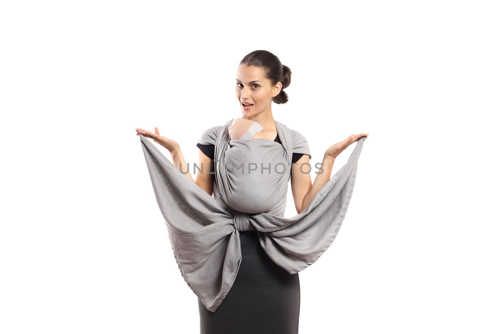 Babywearing attractive young mother with baby in grey carrier, isolated on white. Free hands and active motherhood concept.