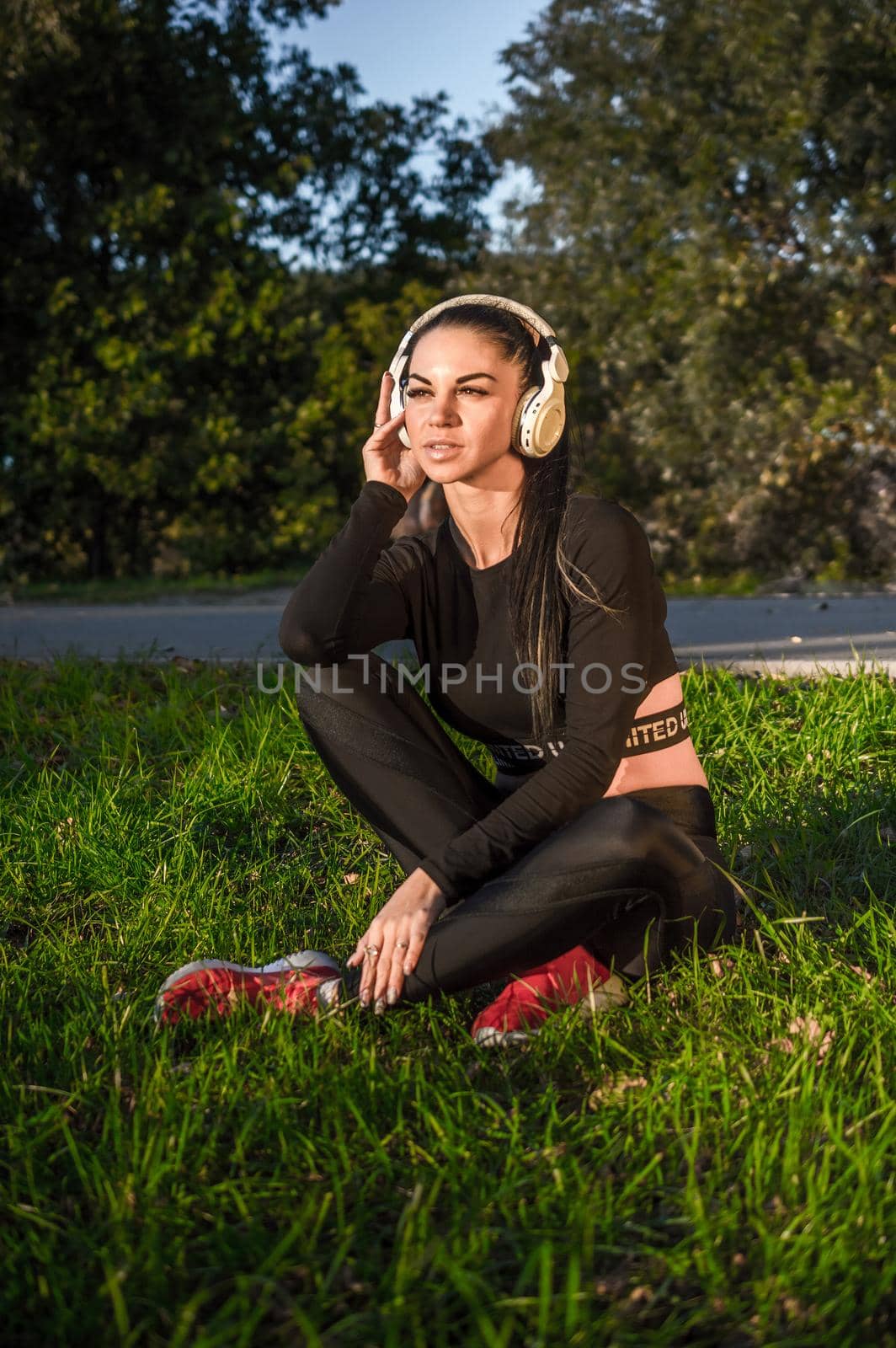 Nice girl listening to the music with headphones./Fit girl lying and relaxing with headphones.