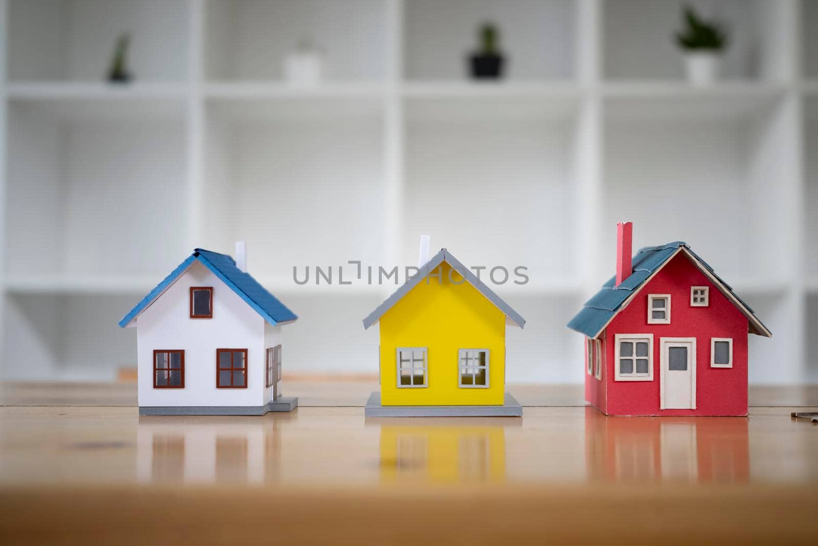 Three small house model on an architects table. New house, insurance and real estate concept.