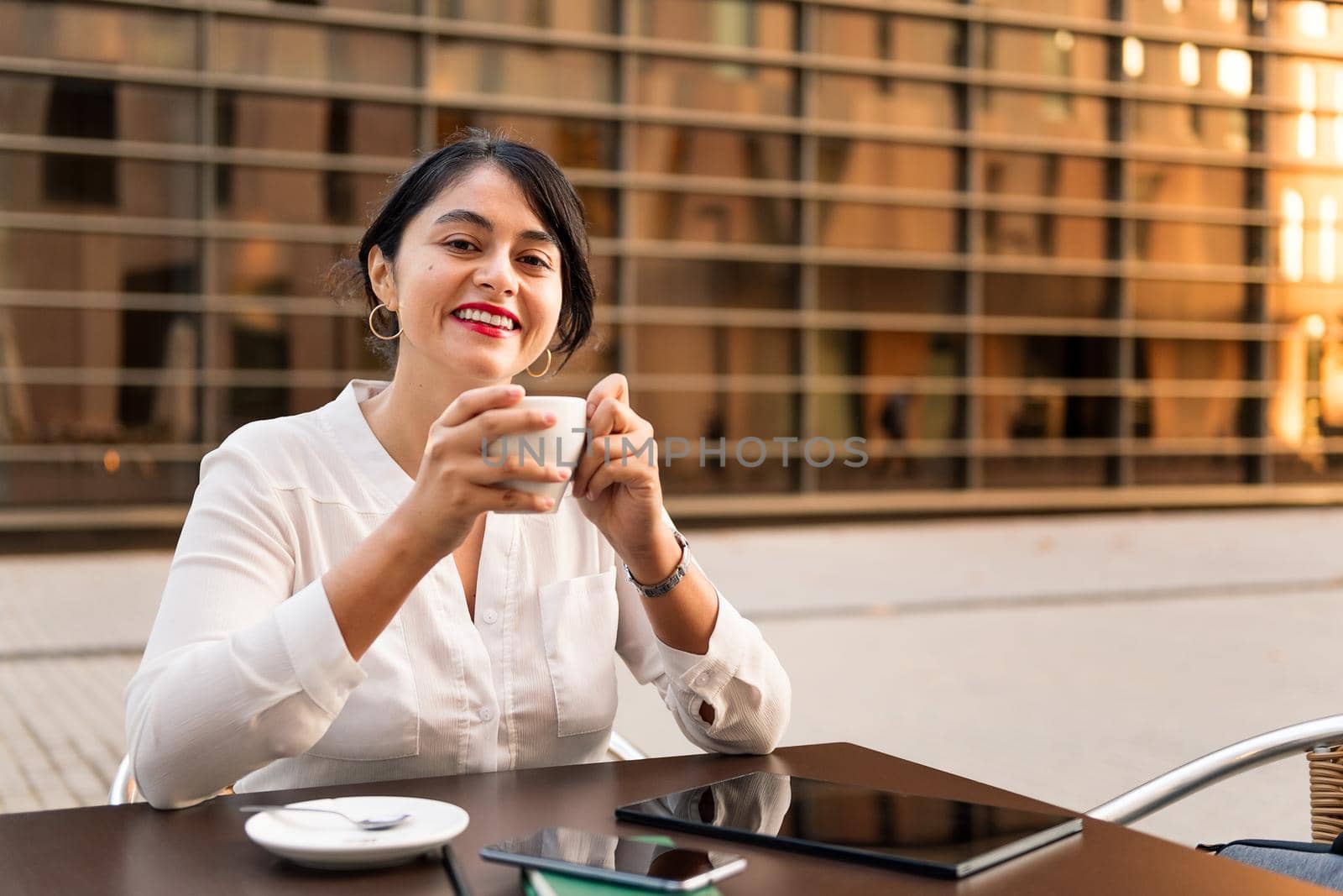 businesswoman smiling with a cup of coffee by raulmelldo