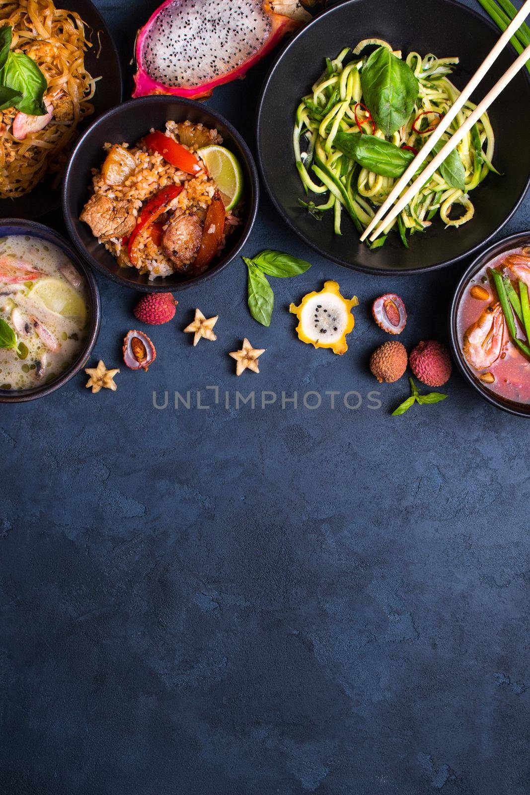 Thai food background. Dishes of thai cuisine. Tom yum, tom kha gai, pad thai noodles, thai fried rice with pork and vegetables khao phat mu, green papaya salad som tam, thai fruits. Space for text