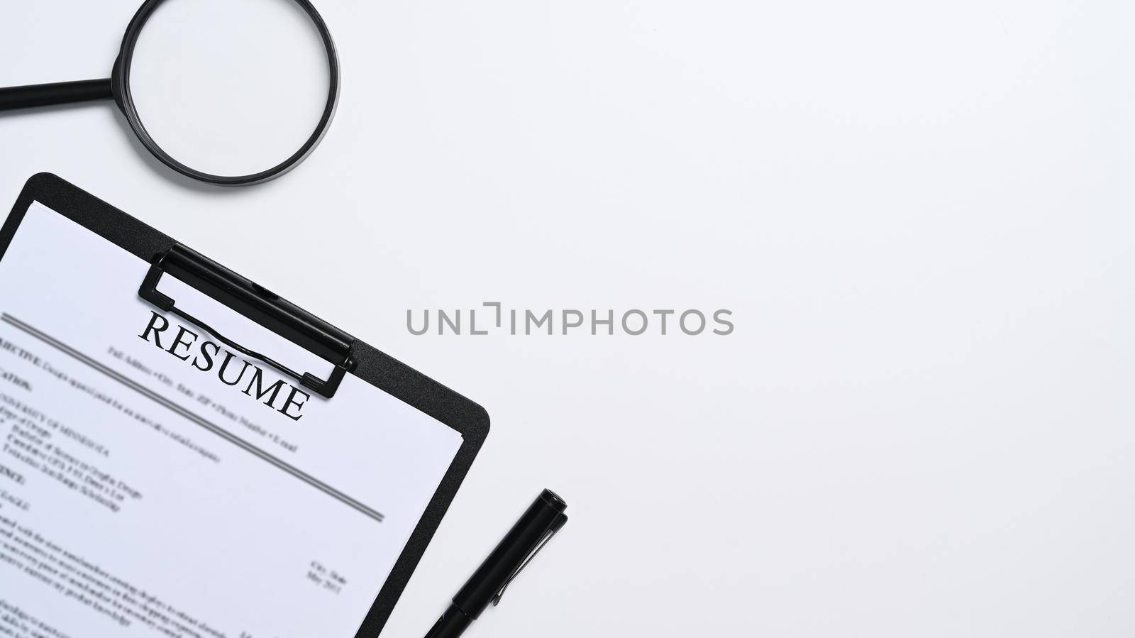 Resumes of applicants and magnifying glass on white background. Job search concept.