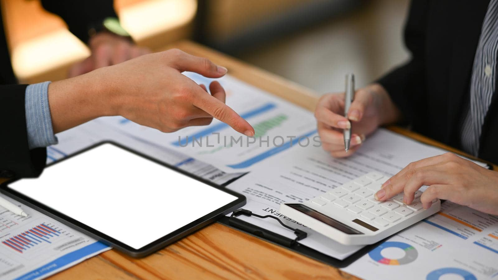 Cropped shot businessman explaining financial data, sharing startup business plan with colleague by prathanchorruangsak