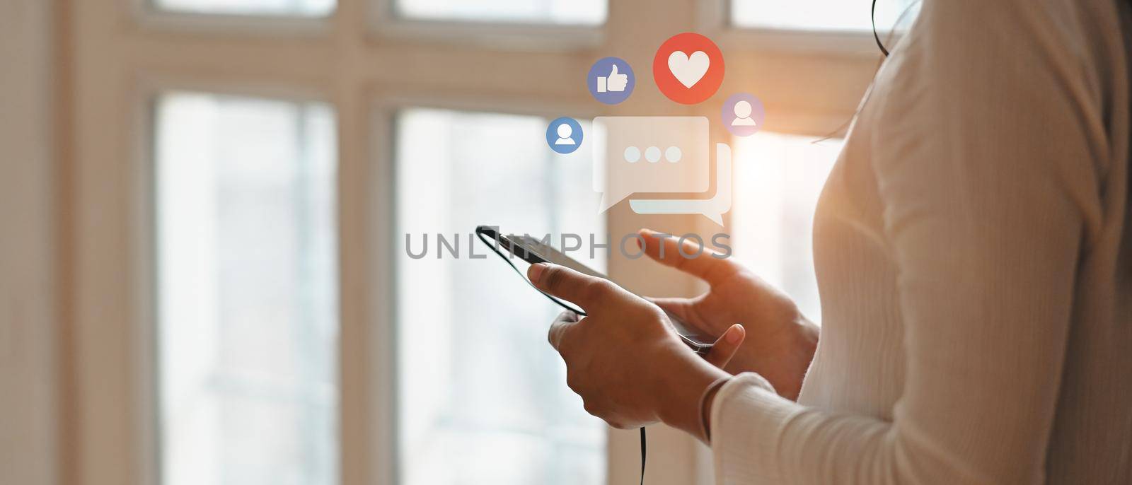 Woman hand holding smartphone with virtual social media icon. Social media and digital online concept.