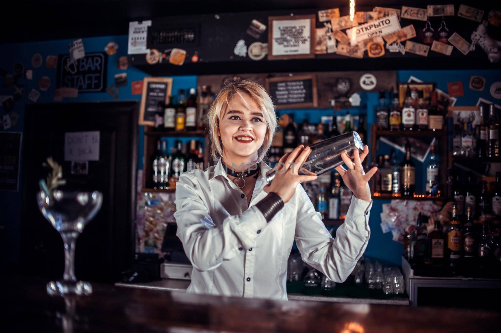 Girl barman creates a cocktail on the taproom by Proff
