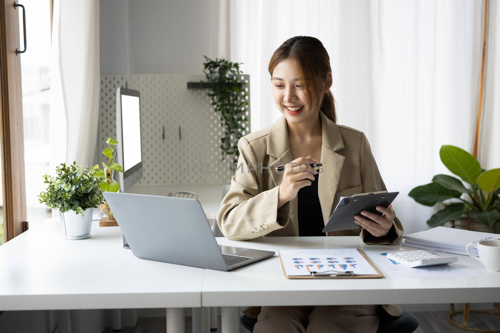 Attractive female finance manager working in a bright modern office.