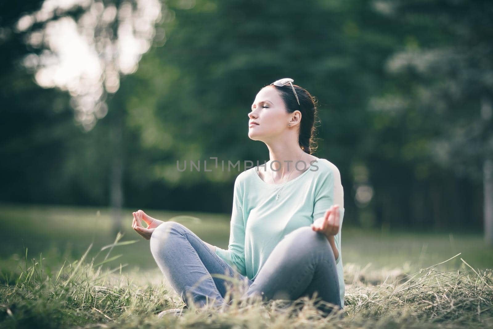 beautiful young woman meditating in Lotus position. photo with copy space