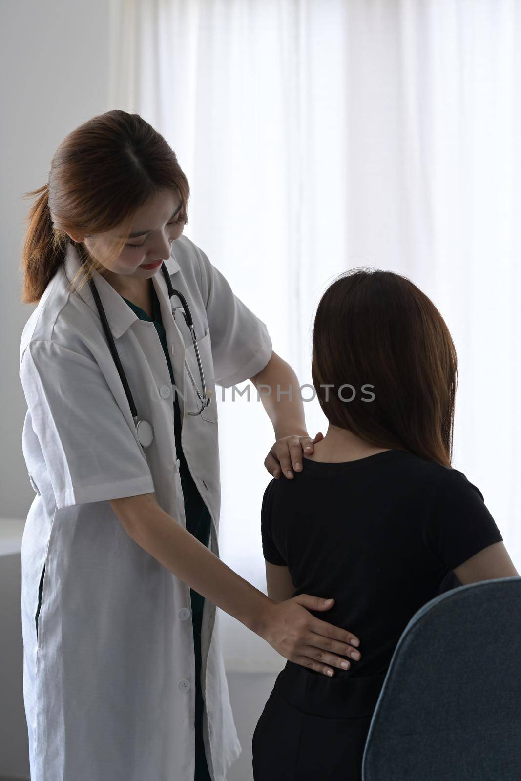 Female physiotherapists doing treatment with patients with back injuries back for relaxation and muscle recovery. by prathanchorruangsak