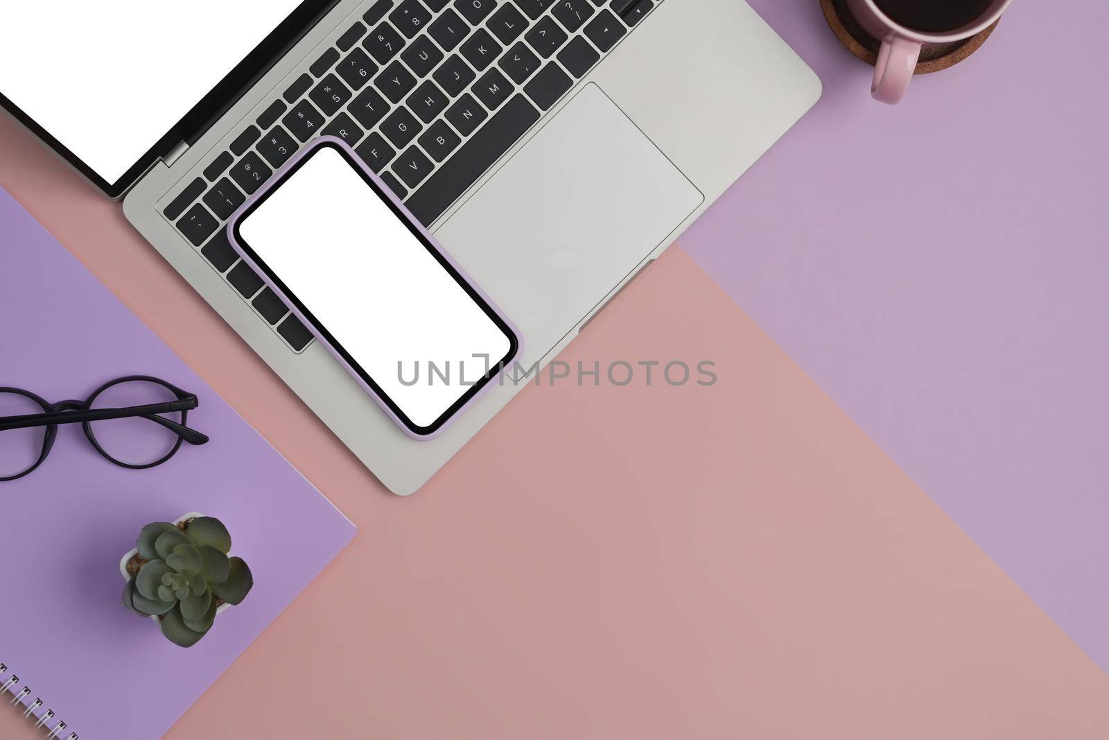 Flat lay mockup laptop computer, smartphone, glasses and coffee cup on two tone background. by prathanchorruangsak