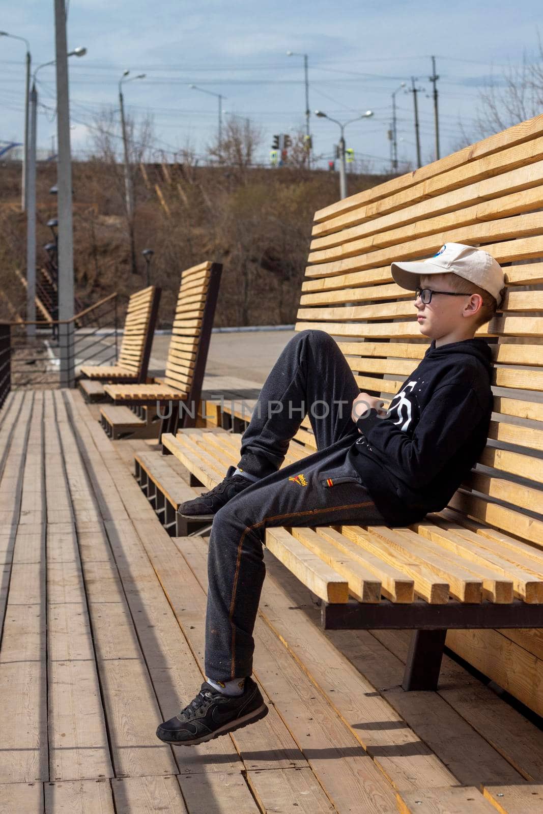 Portrait of happy child in glasses. Summer vacation concept. Smiling kid boy in hat and glasses near sea. Sustainable climate visuals