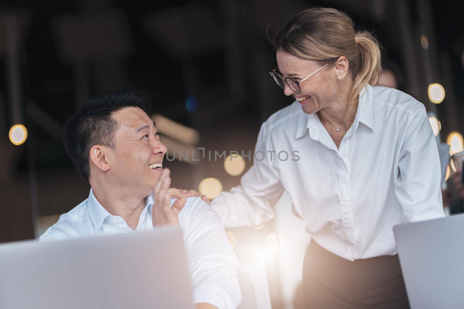 excited happy emotional colleagues in office working with computer in modern office