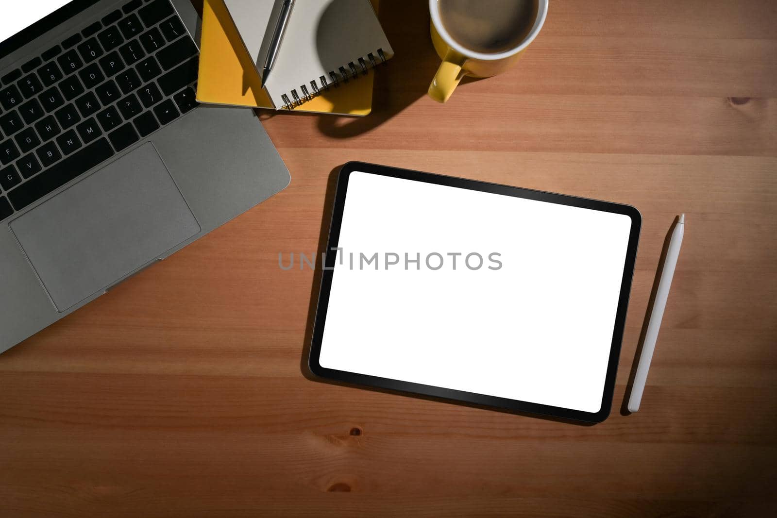 Flat lay mock up digital tablet, stylus pen and laptop computer on wooden background. by prathanchorruangsak