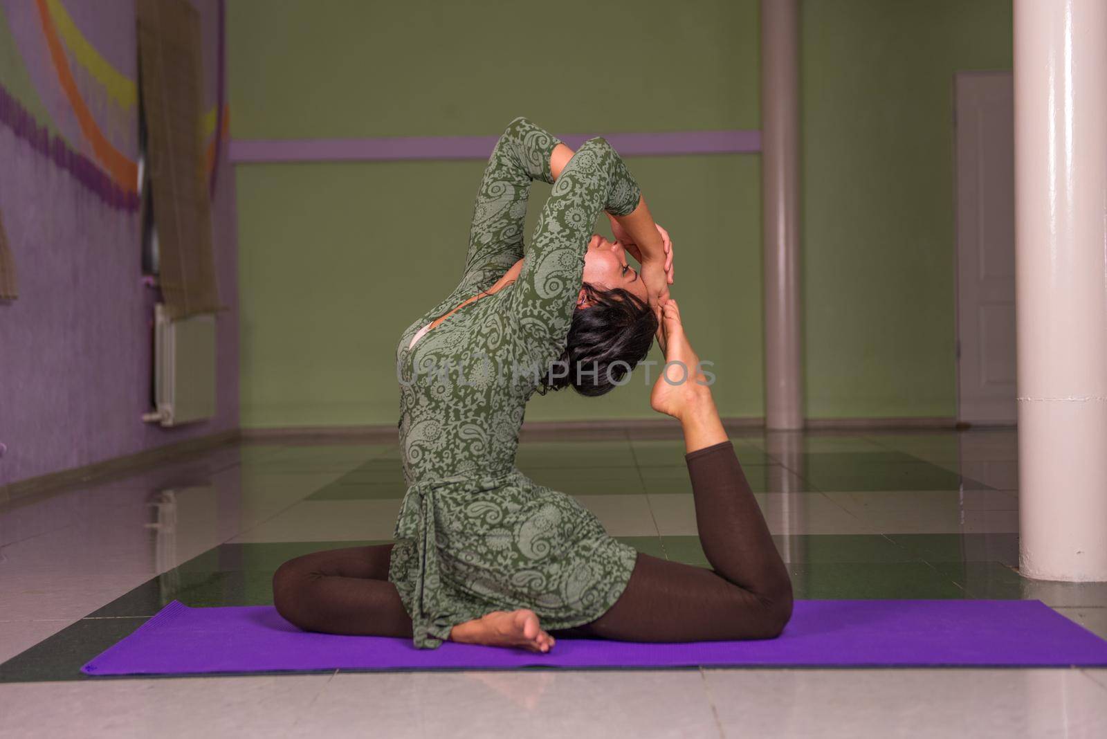 Yoga instructor poses yoga positions ./Yogi does exercises yoga .