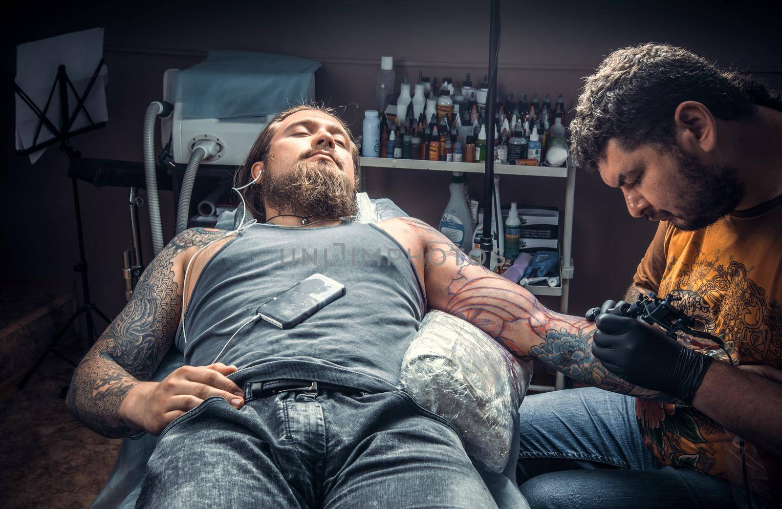 Tattoo artist create tattoo in studio./Professional tattoo artist makes tattoo pictures in tattoo studio.