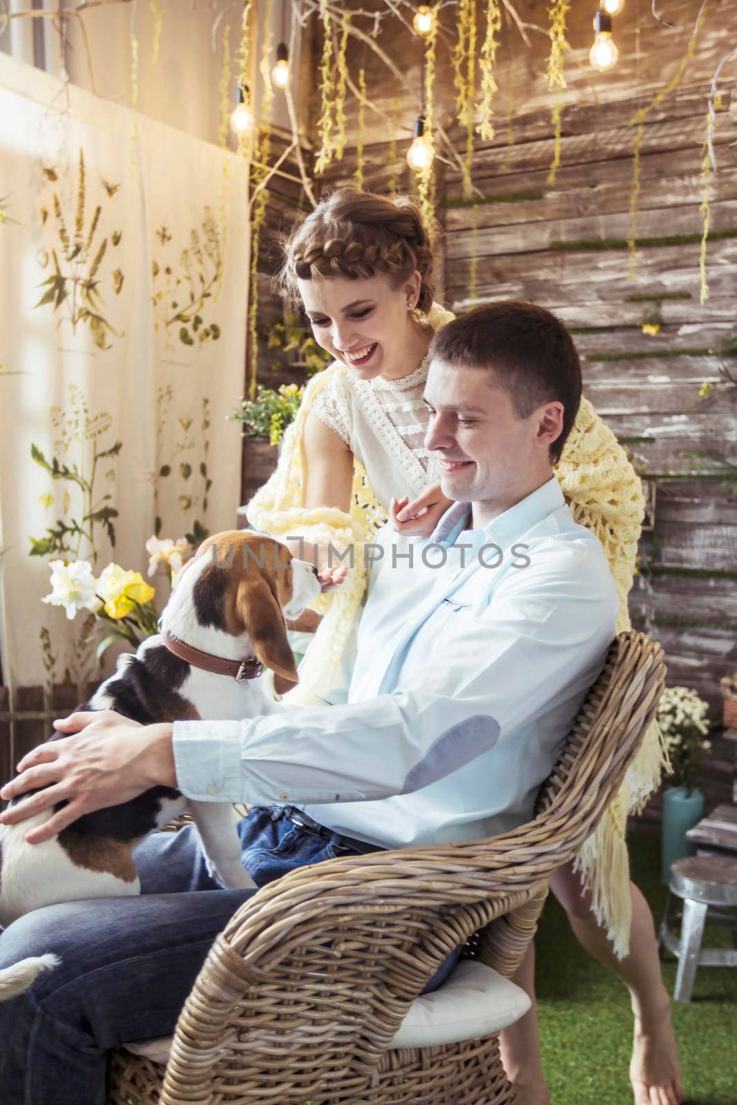 happy couple playing with his beloved dog in the living room