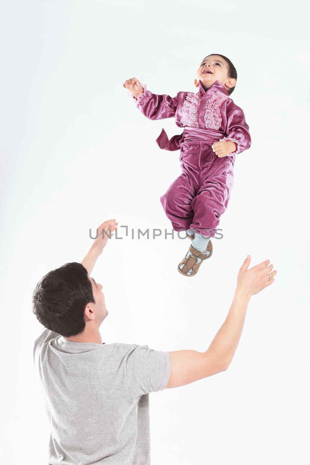 happy father playing with his son who is dressed in a Gypsy costume by SmartPhotoLab