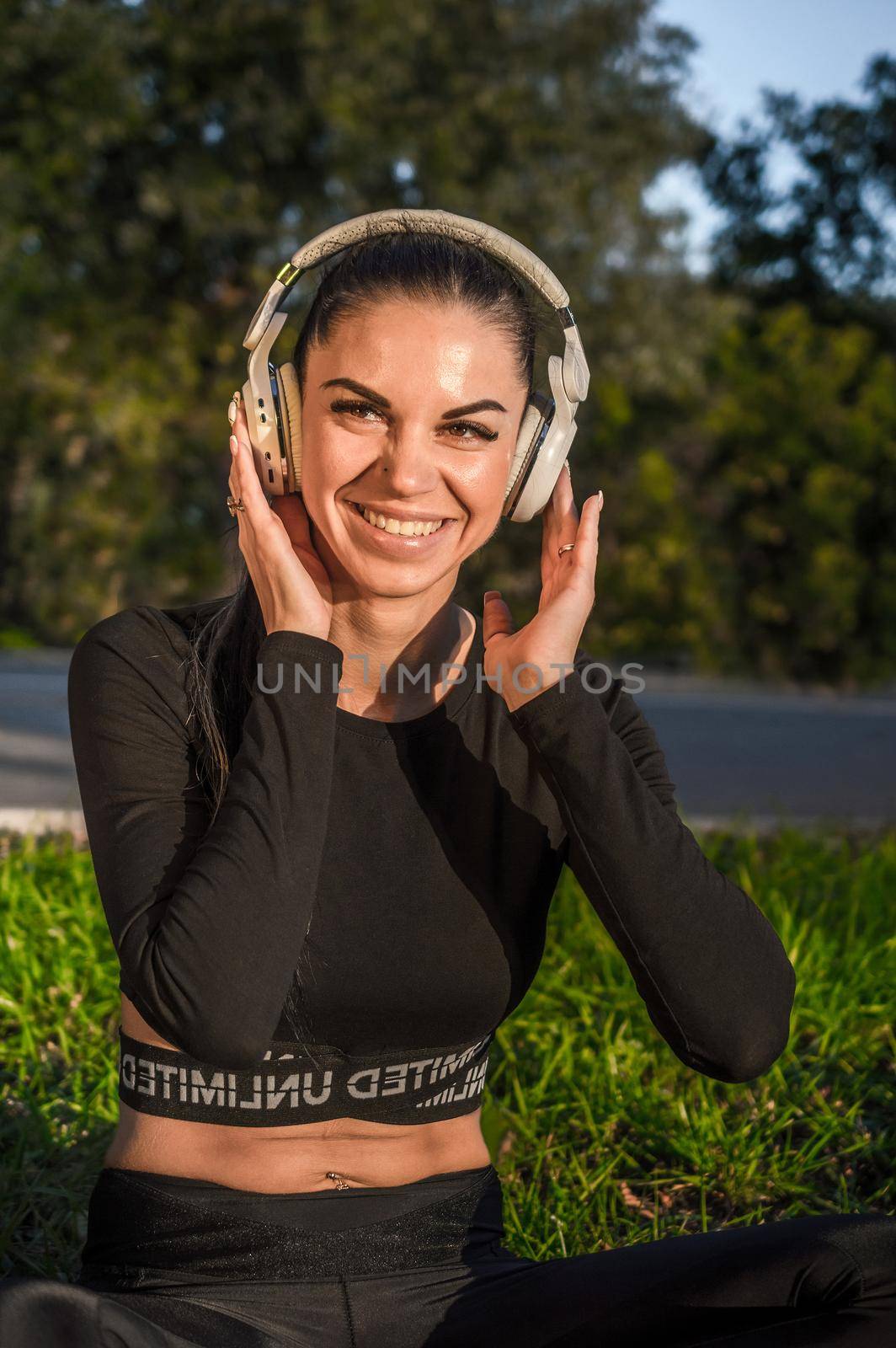 Sporty girl with headphones outdoors enjoying music by Proff