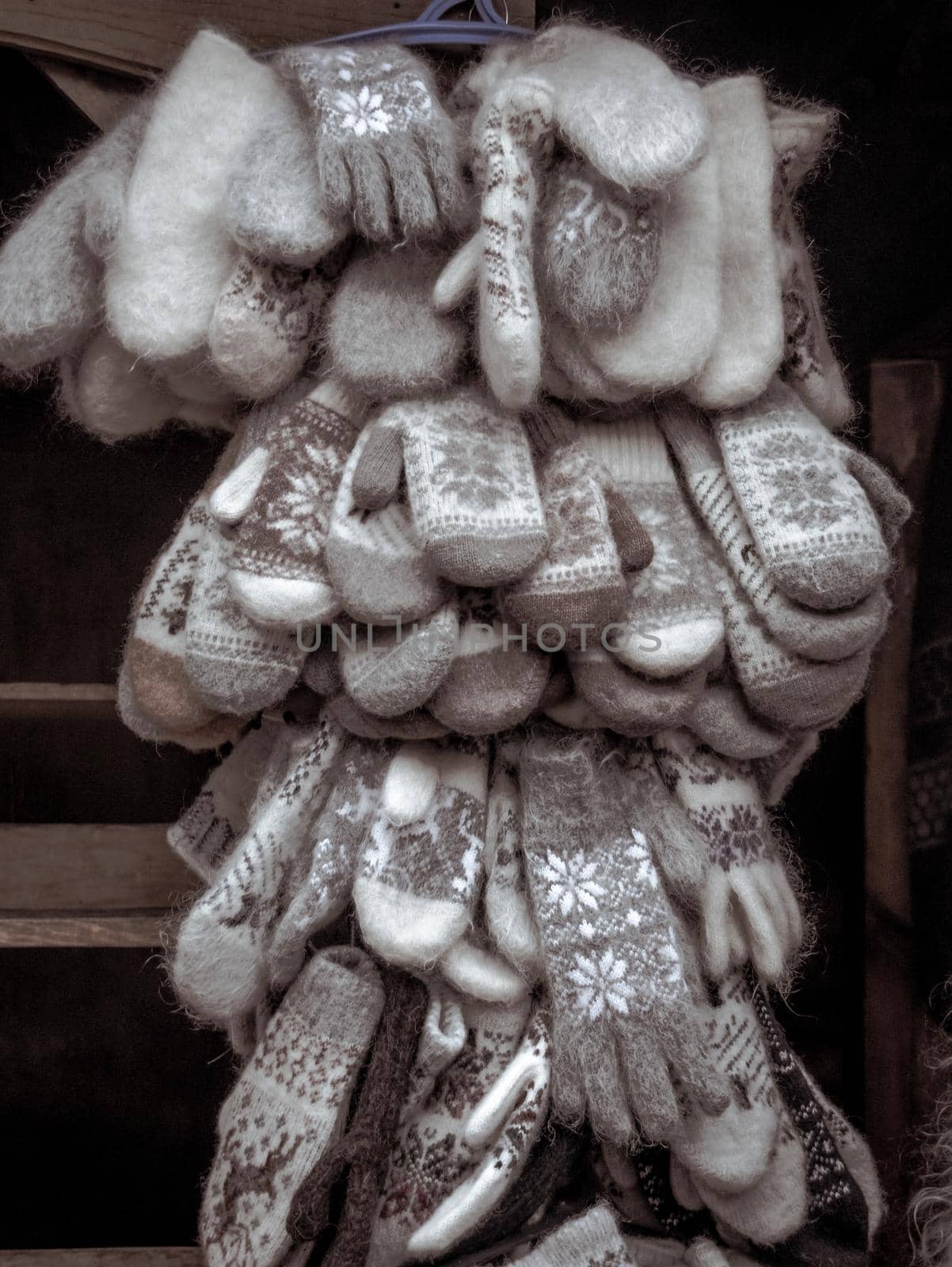 Many knitted woolen gloves and mittens in a bundle