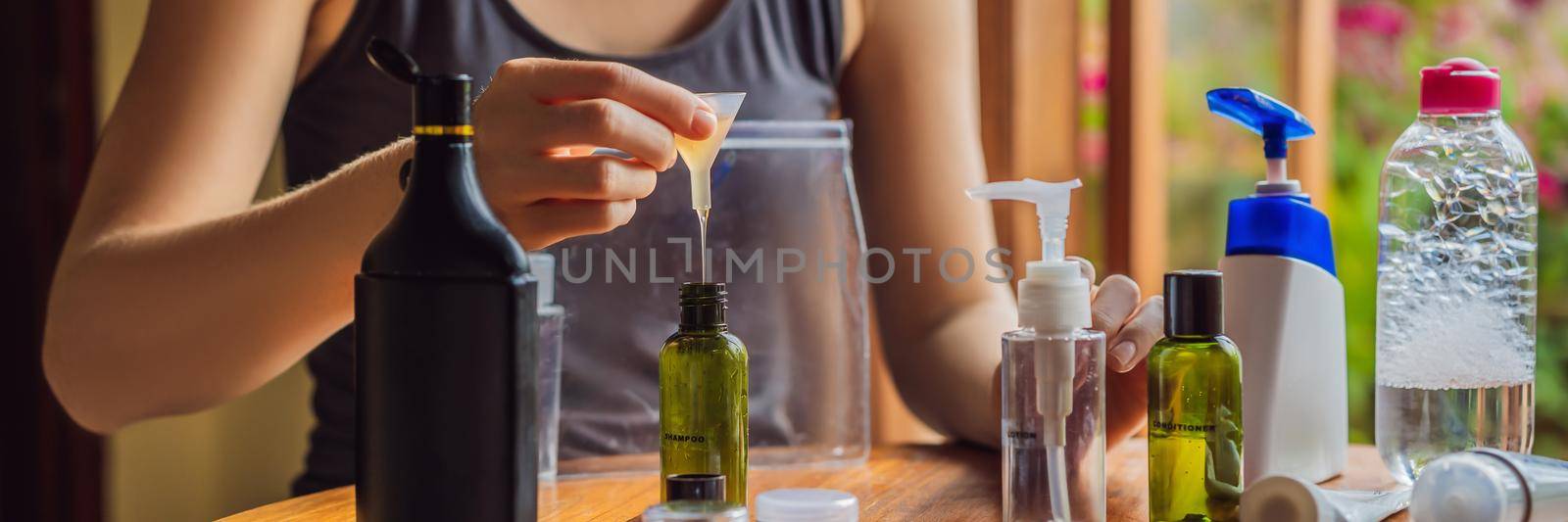 Travel kit for transporting cosmetics on an airplane. Cosmetics are ready to be poured into small bottles. A woman shifts cosmetics to take with her. BANNER, LONG FORMAT