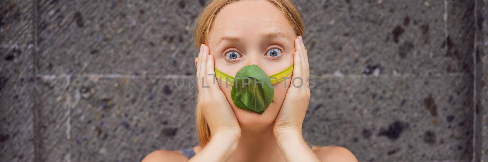 The child made himself a face mask from the leaves to protect himself from air pollution. Air purification. Trees purify the air concept. BANNER, LONG FORMAT