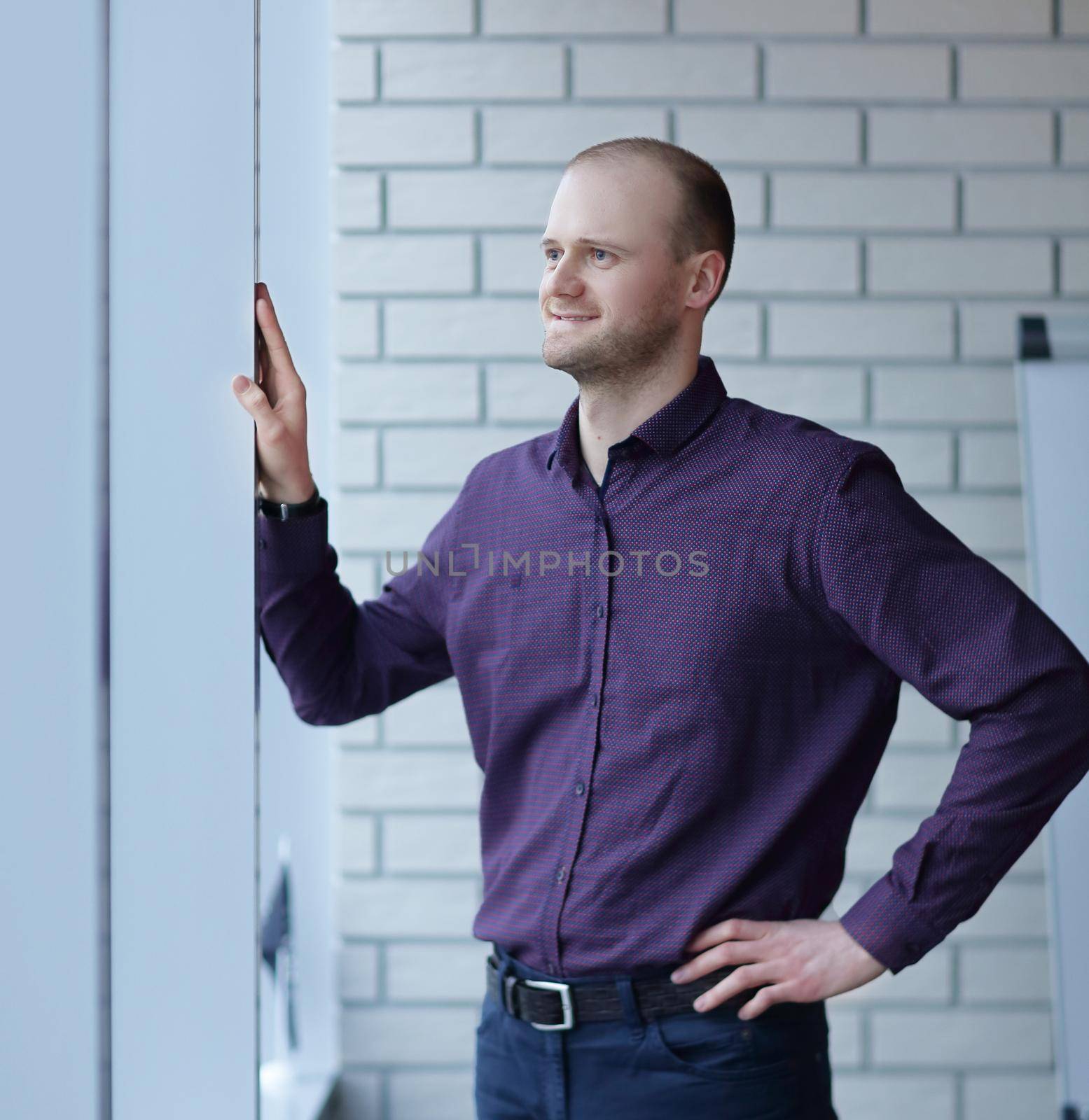 Pensive man thinking of something behind venetian blind by SmartPhotoLab