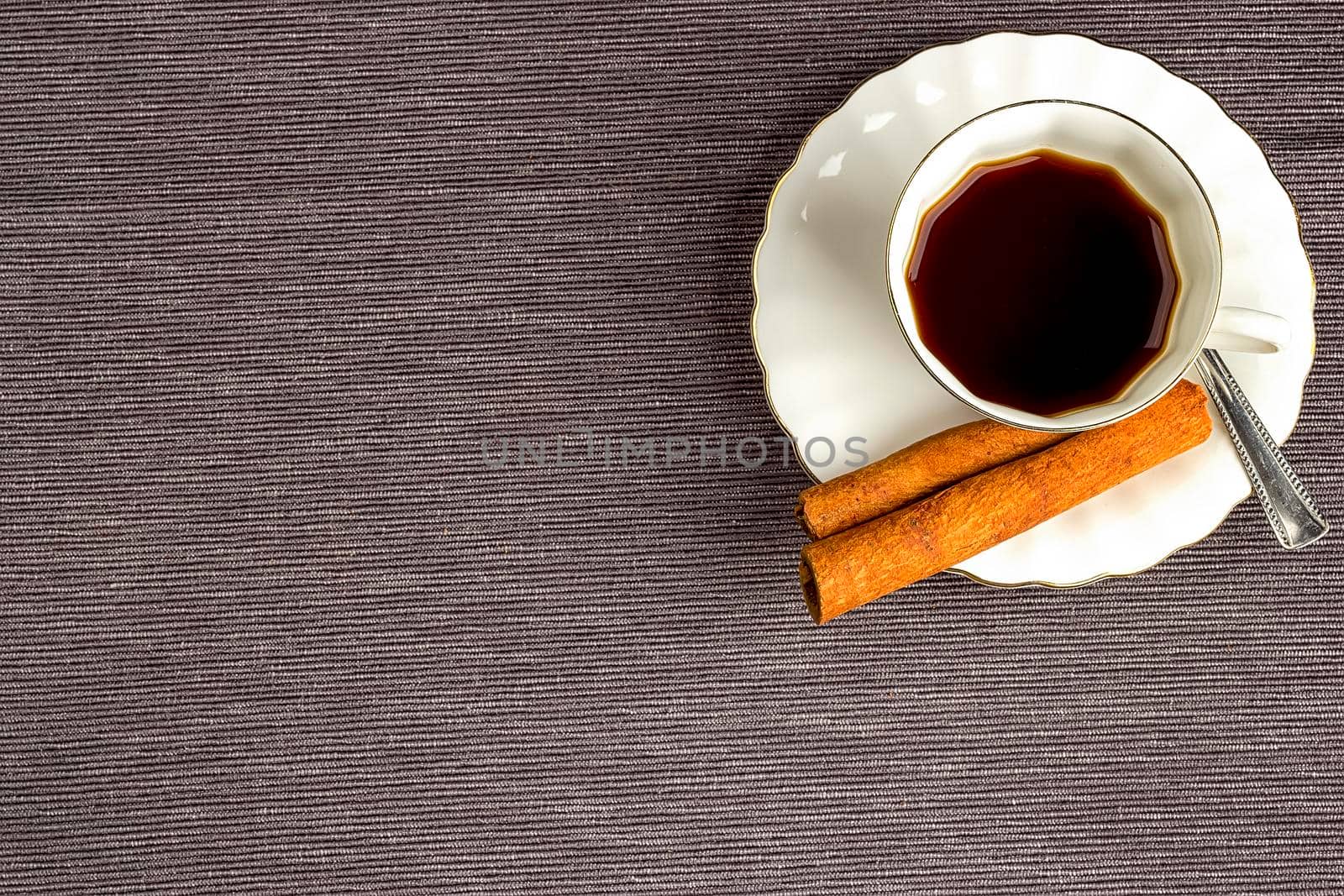 coffee in a coffee cup and cinnamon with copy space. Top view
