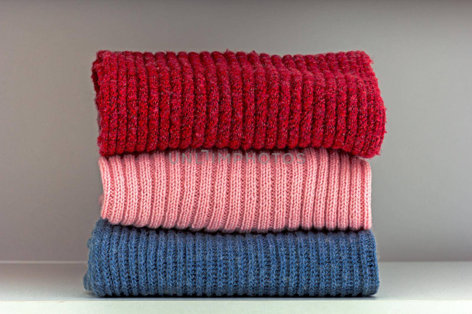 Stack of wool cloth on shelf by TatianaFoxy