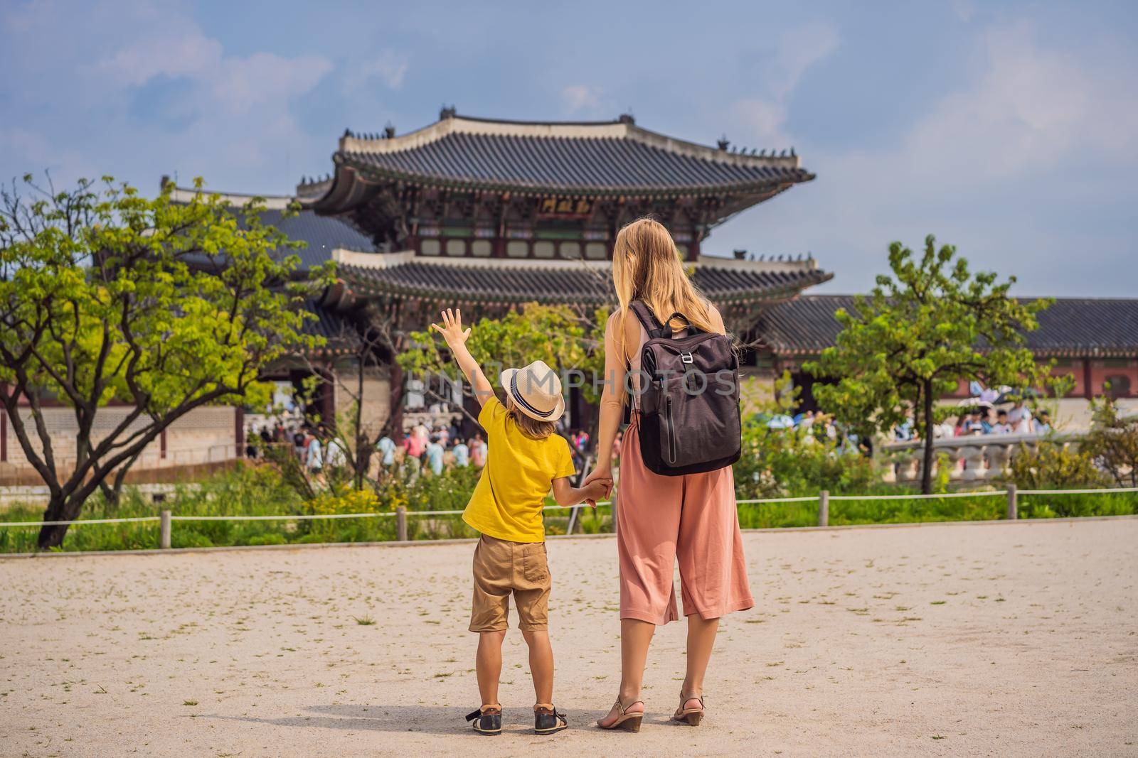 Mom and son tourists in Korea. Gyeongbokgung Palace grounds in Seoul, South Korea. Travel to Korea concept. Traveling with children concept.