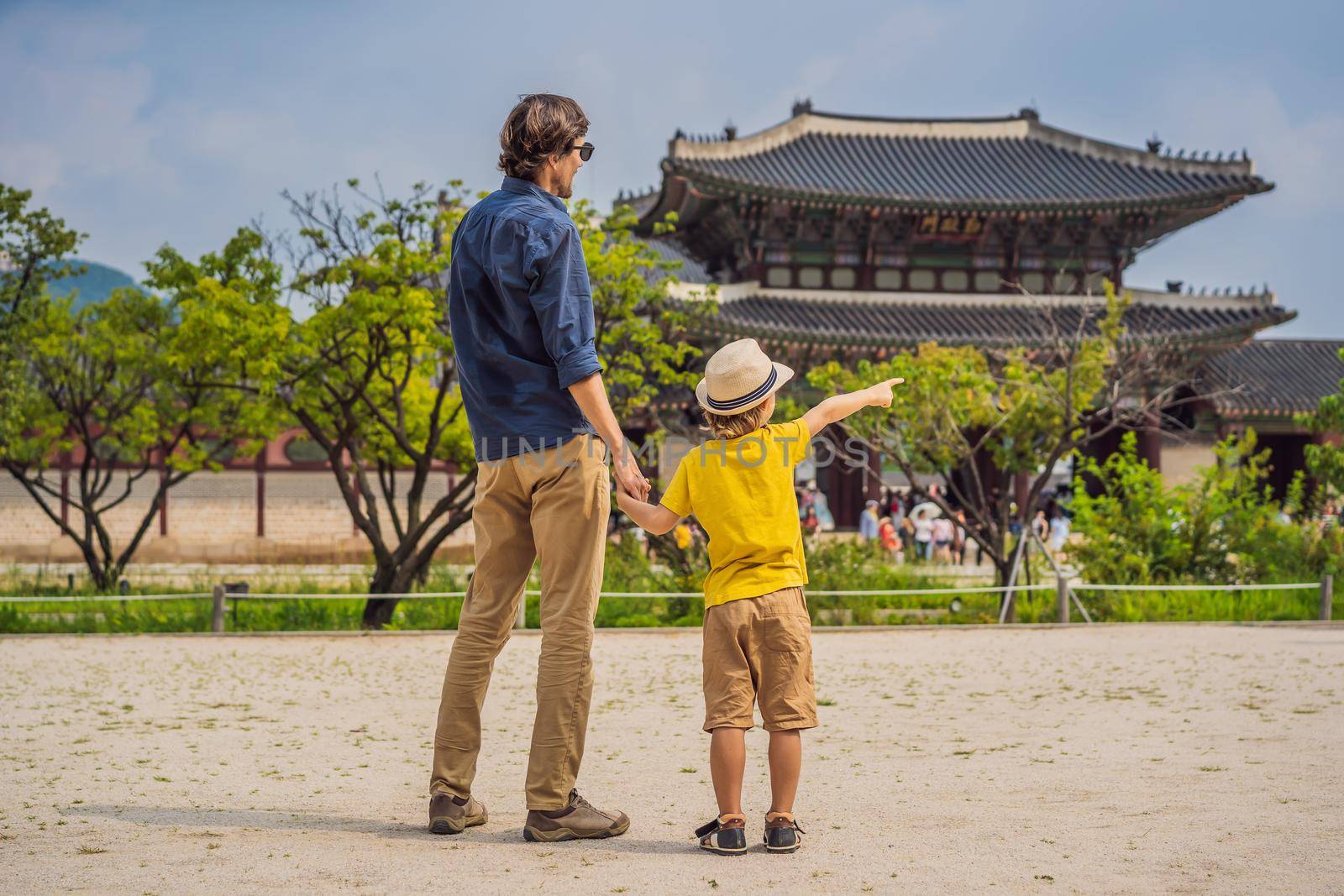 Dad and son tourists in Korea. Gyeongbokgung Palace grounds in Seoul, South Korea. Travel to Korea concept. Traveling with children concept.