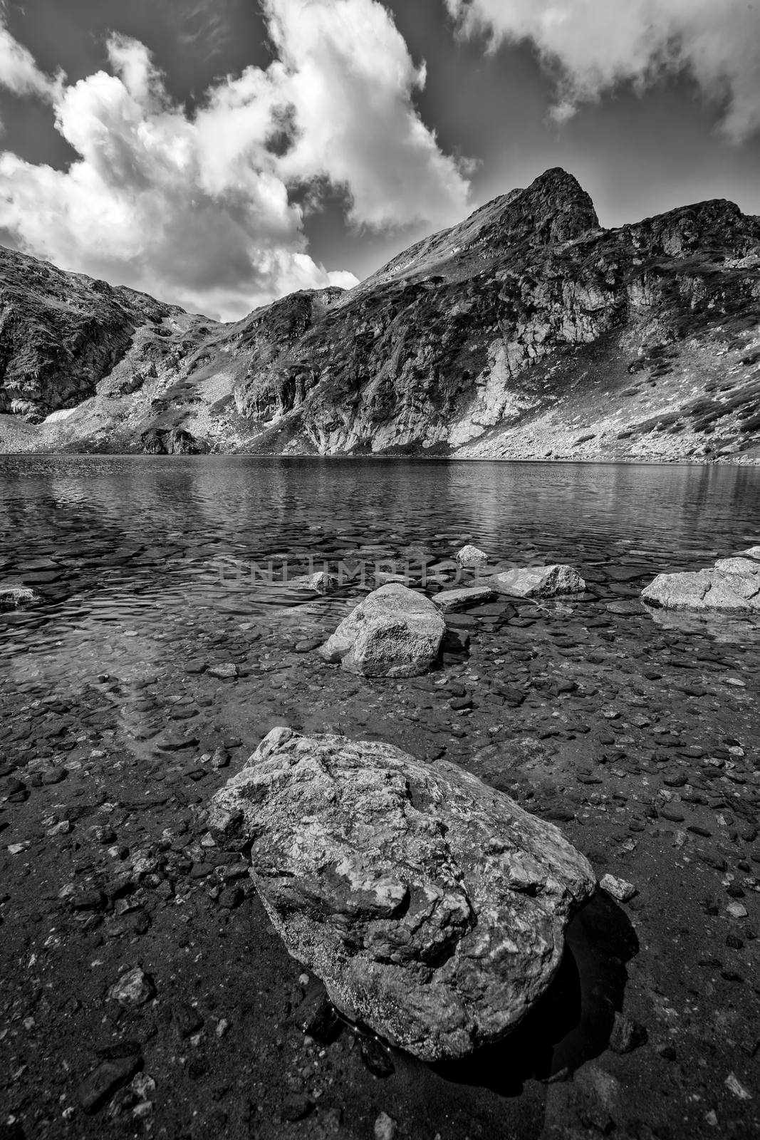 beauty black and white  landscape on the mountain lake with a big rock at the front