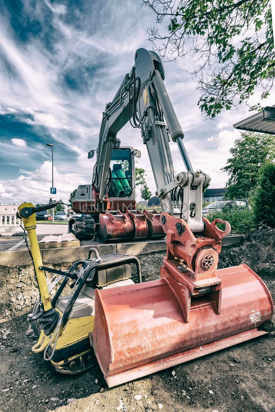 A stopping excavator at the construction site. Vintage view by EdVal