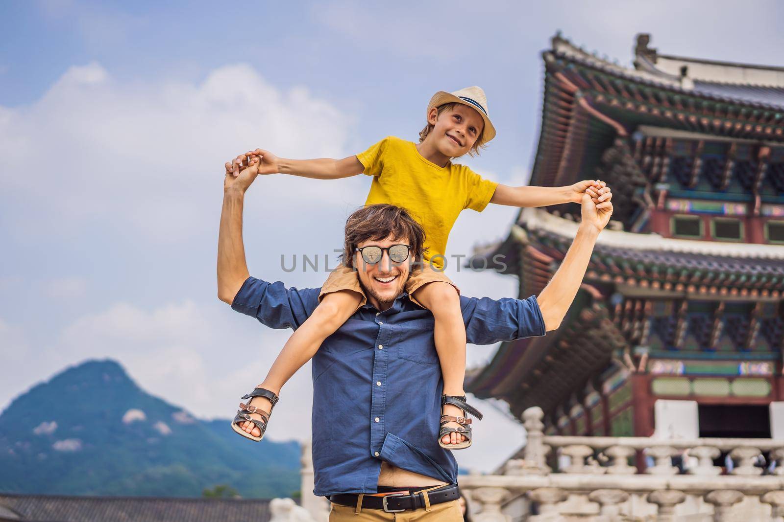 Dad and son tourists in Korea. Gyeongbokgung Palace grounds in Seoul, South Korea. Travel to Korea concept. Traveling with children concept.