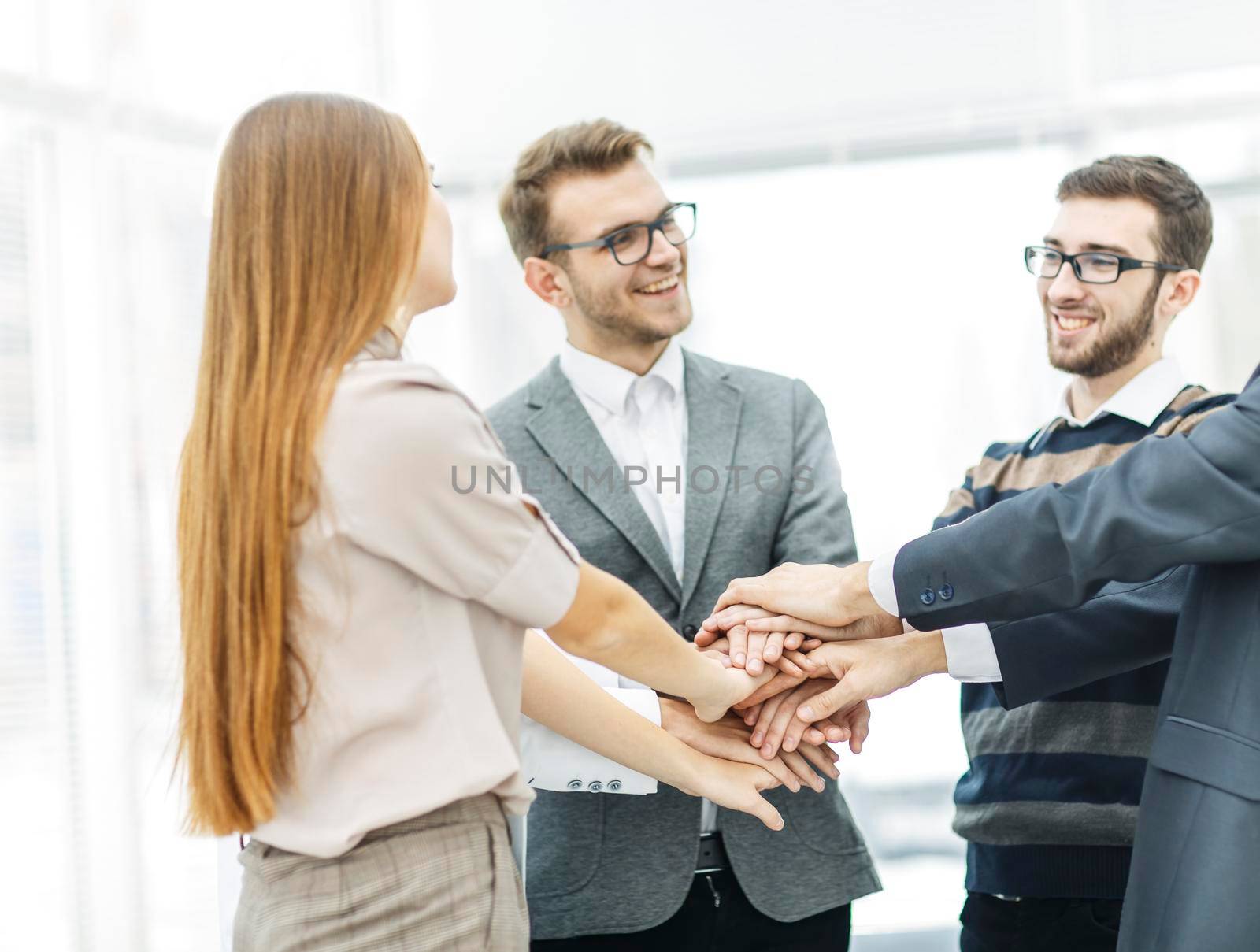 friendly business team standing in a circle and joining his hands together