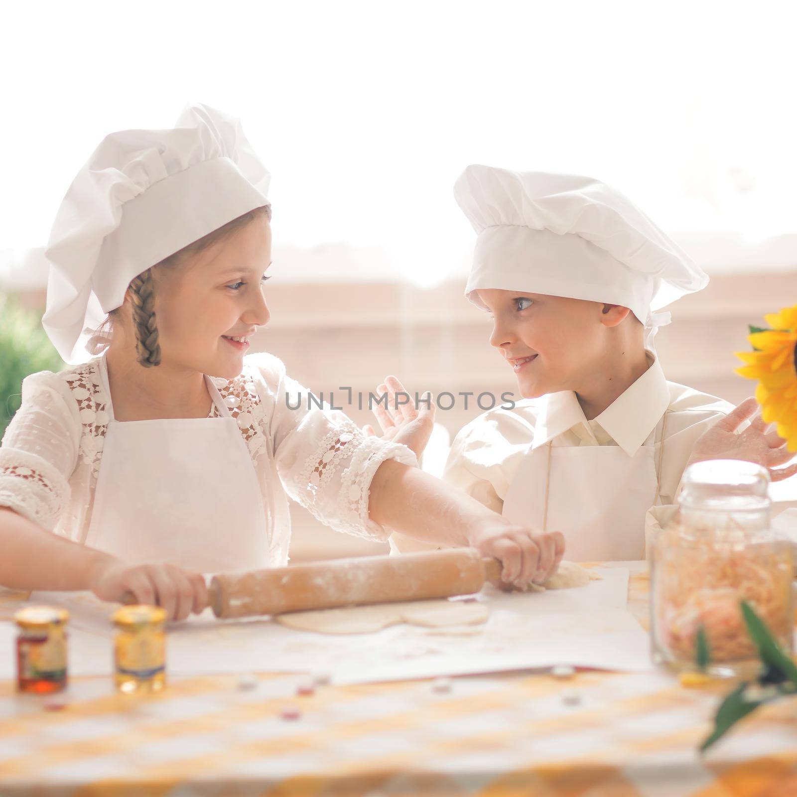 happy little children in the form of a chef to prepare delicious by SmartPhotoLab