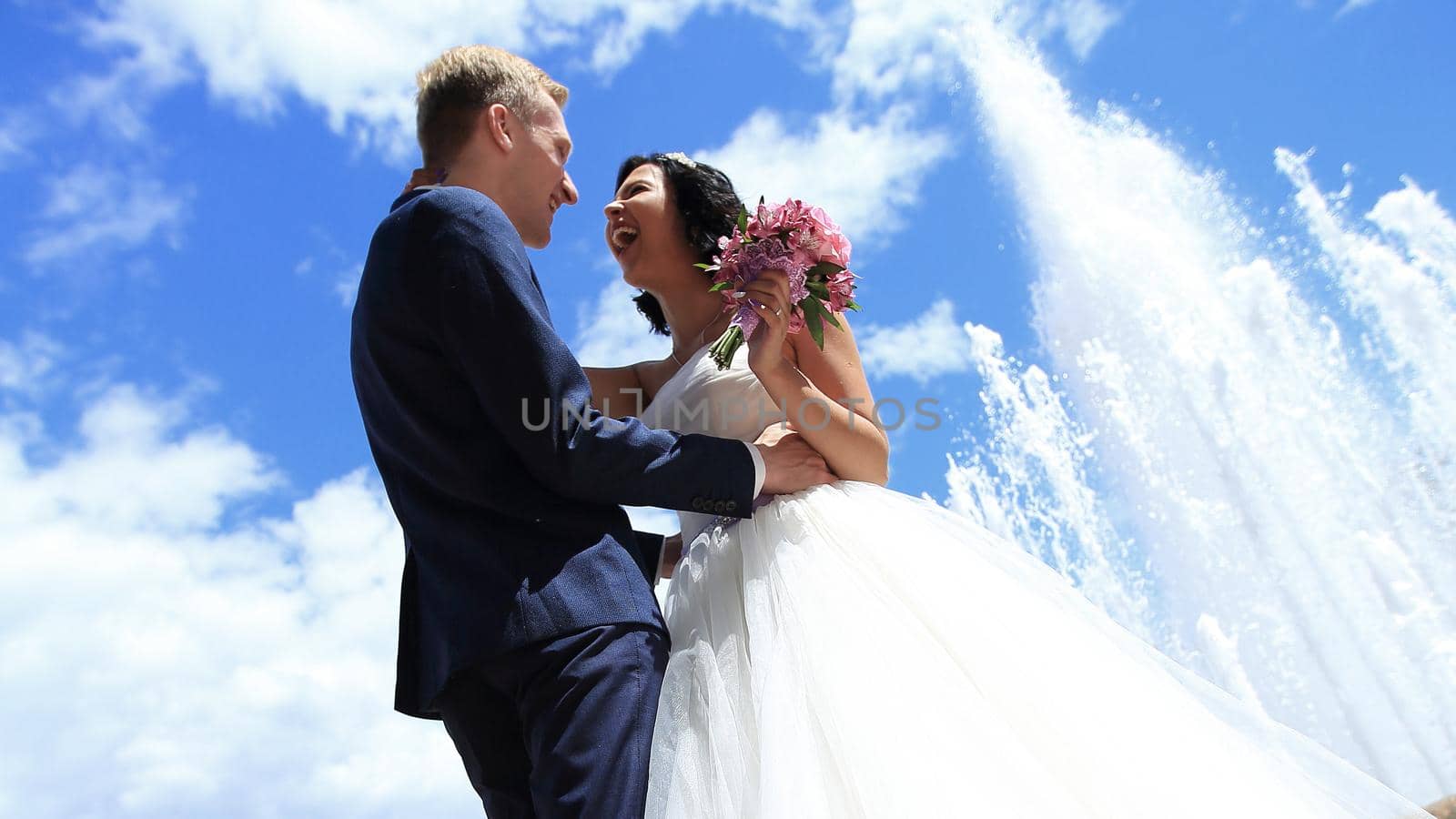 bride and groom on the background of the summer sky.photo with copy space