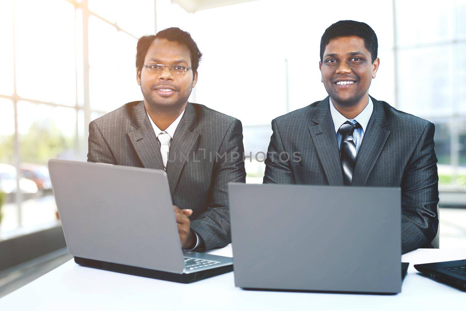 Interracial business team working at laptop in a modern office