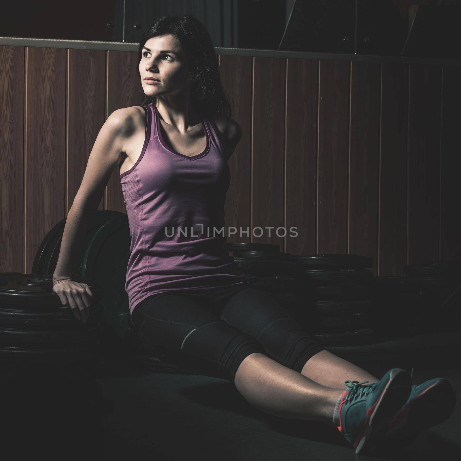 Modern business woman next to a fitness machine at a fitness lesson by SmartPhotoLab