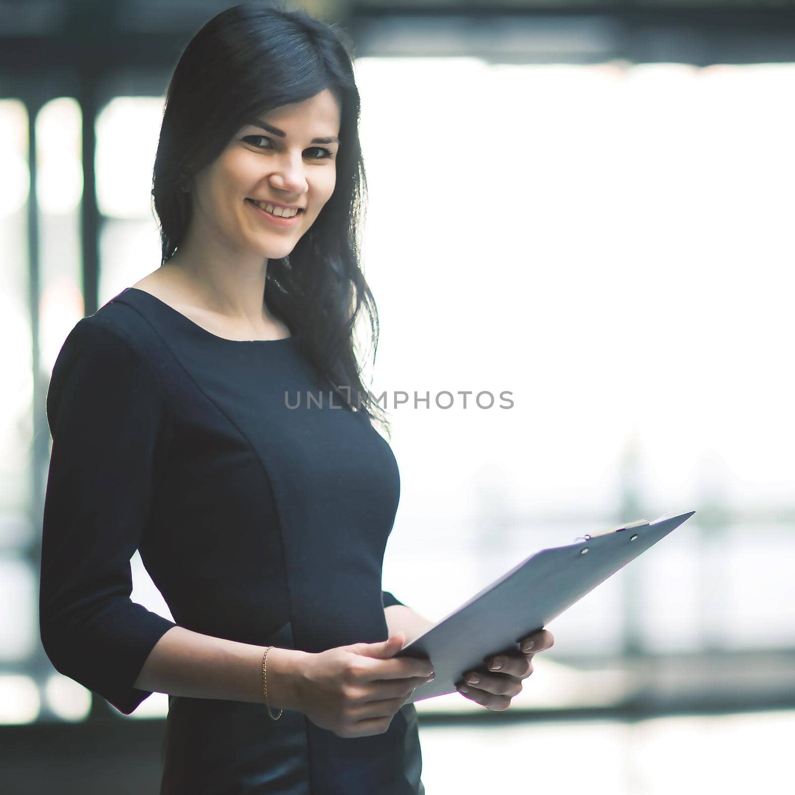 business woman with documents on the background of a spacious office.photo has empty space for your text