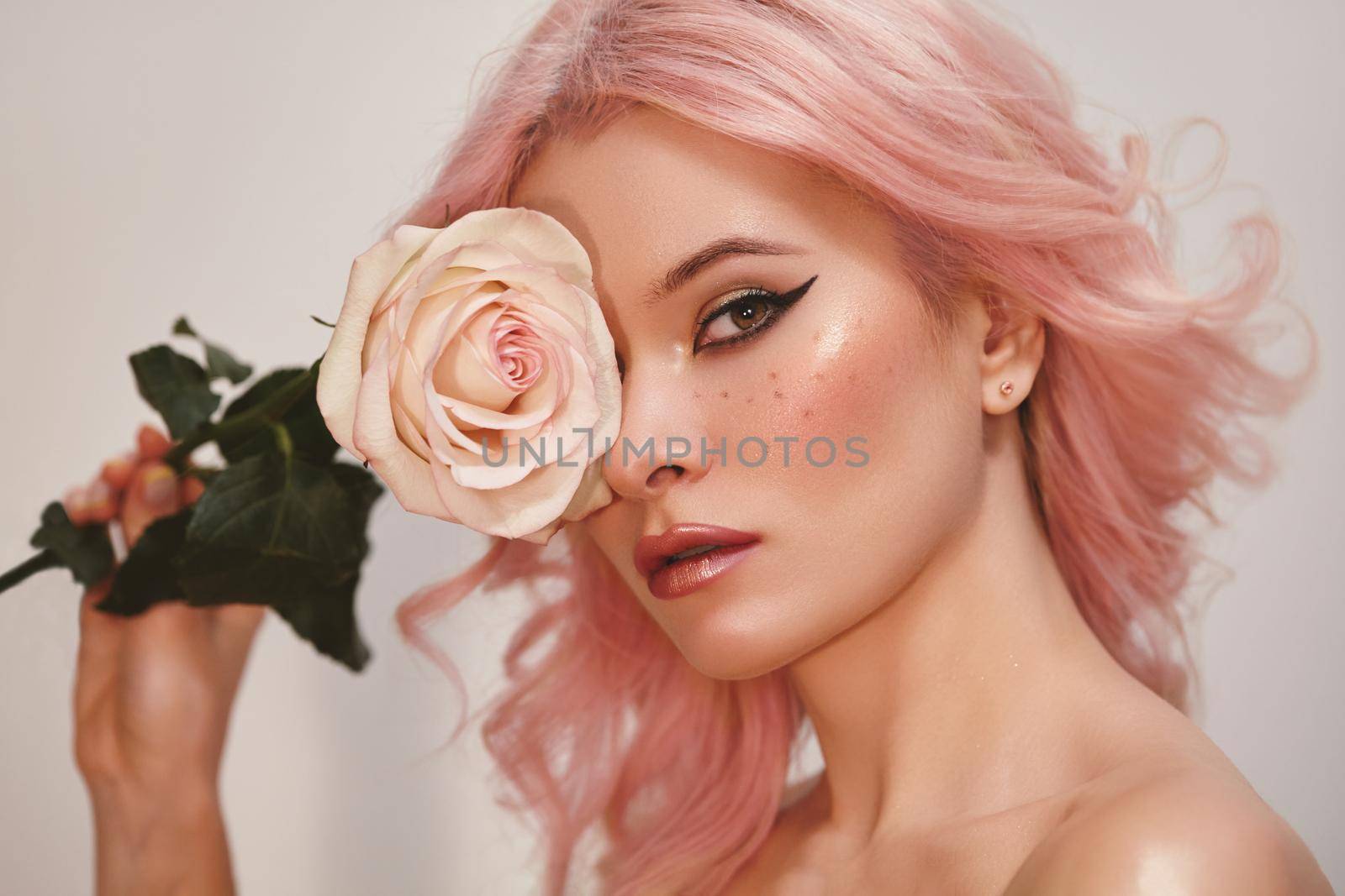 Soft-Girl Style with Trend Pink Flying Hair, Fashion Make-up. Woman Face with Fake Freckles, Blush Rouge and Rose Flowers. Valentines Day Look, Womens Day, March 8 or Freshness Spring Style