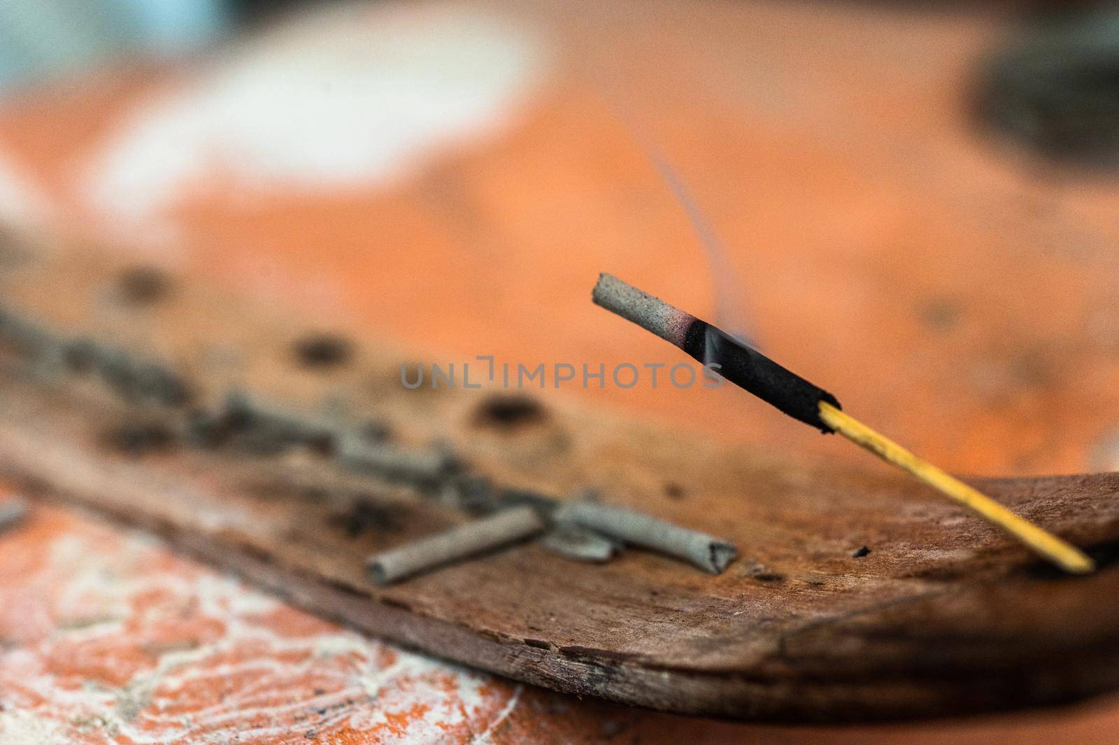 Incense stick and smoke from incense burning. Beautiful smoke. Blurred background and design with copy space