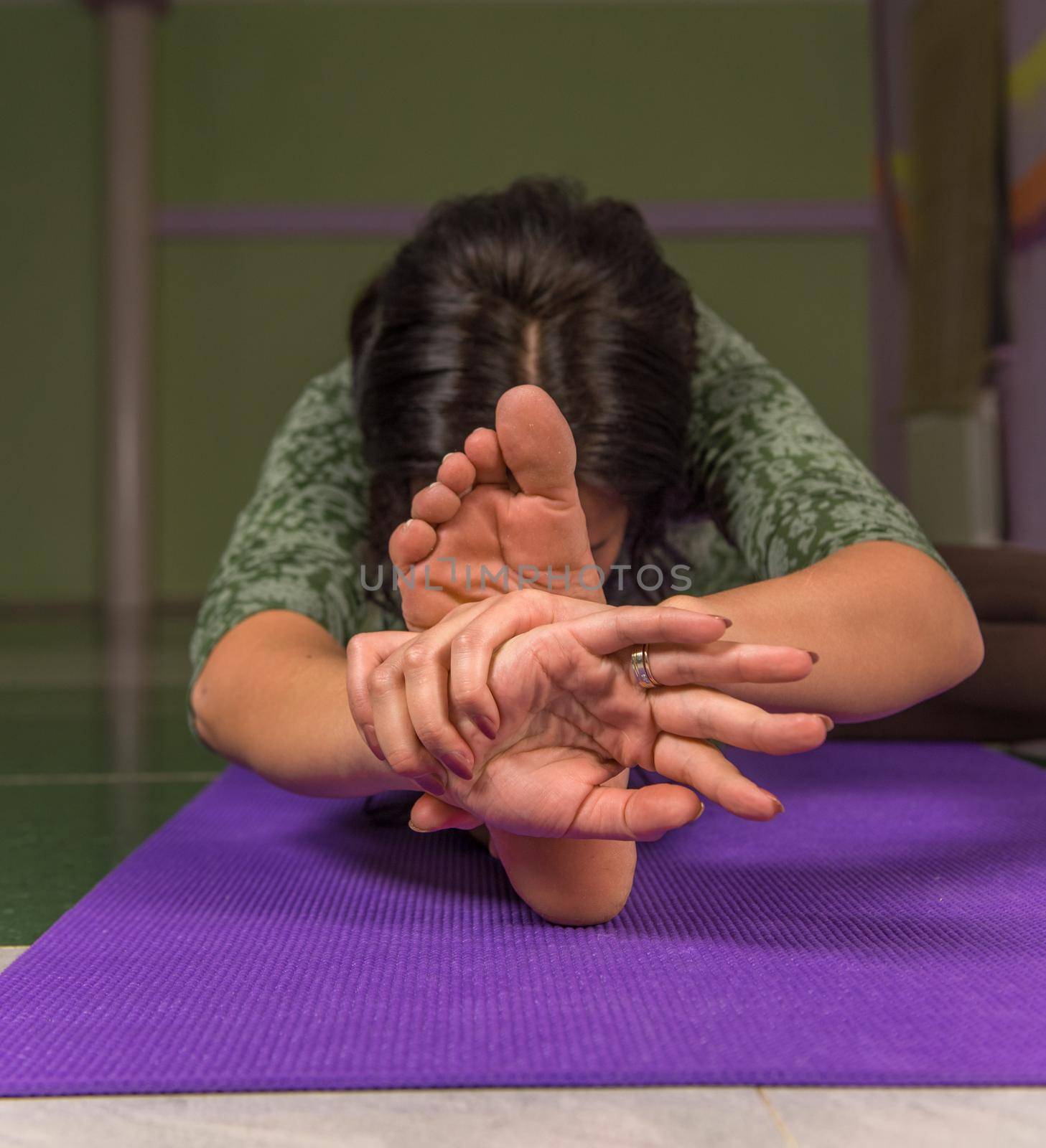 Yoga master doing yoga stretches ./Professional yoga trainer works out yoga stretches .