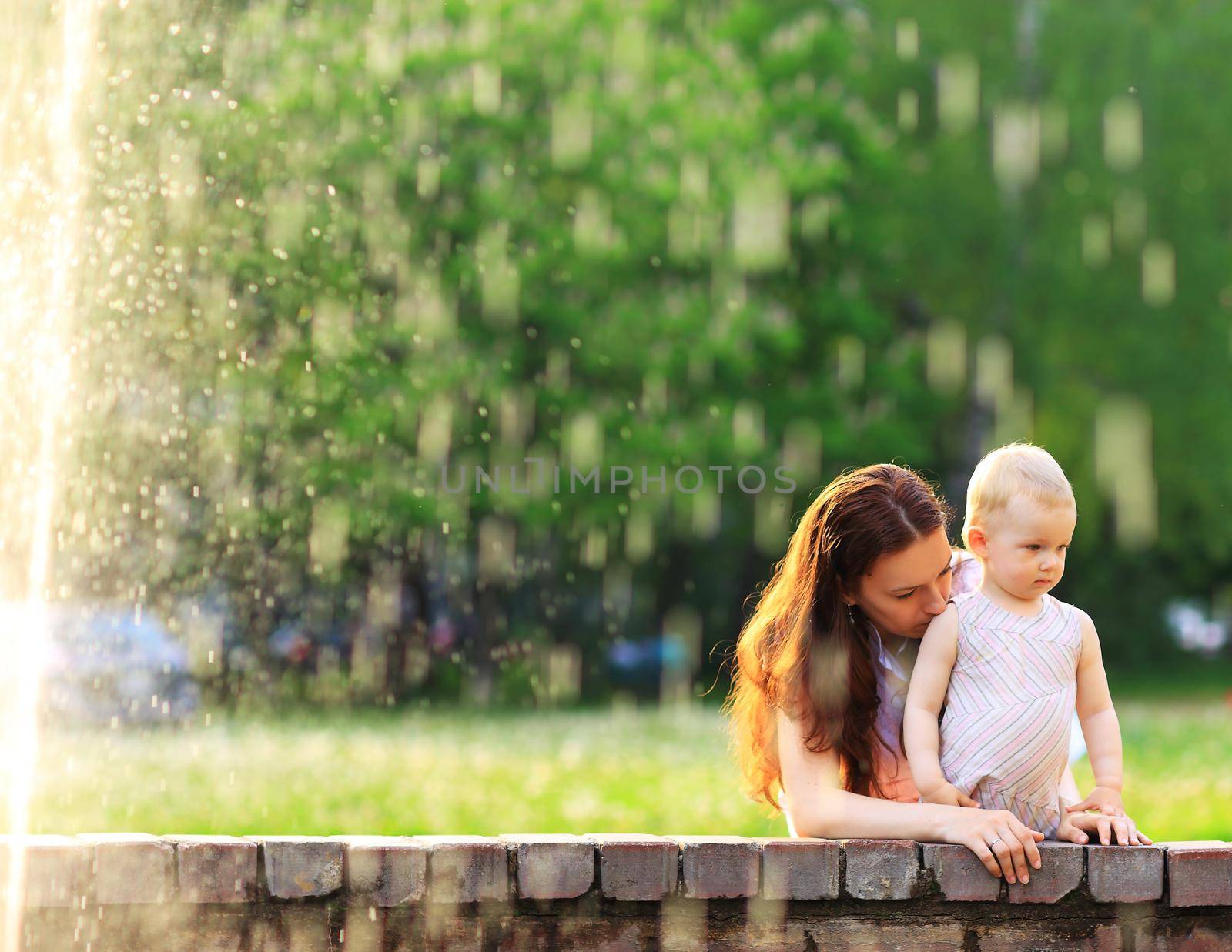 Beautiful Mother And Baby outdoors. Nature. Beauty Mum and her Child playing in Park by SmartPhotoLab