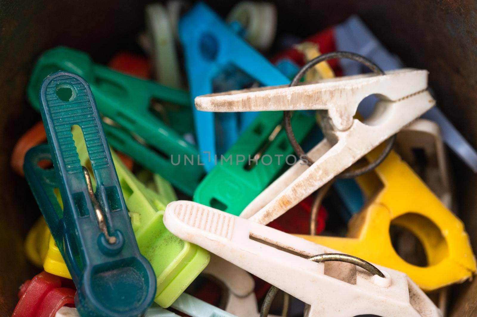 Hooks for drying wet clothes. Various colors close up. High quality photo. by Peruphotoart