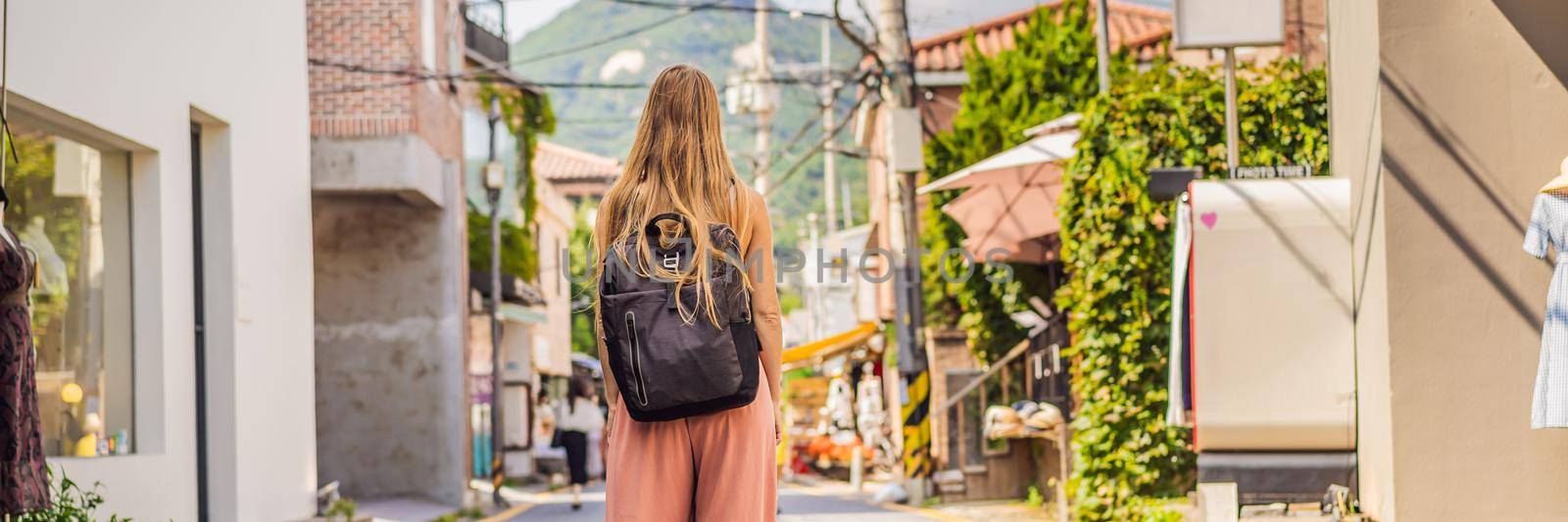 Young woman tourist in Bukchon Hanok Village is one of the famous place for Korean traditional houses have been preserved. Travel to Korea Concept. BANNER, LONG FORMAT