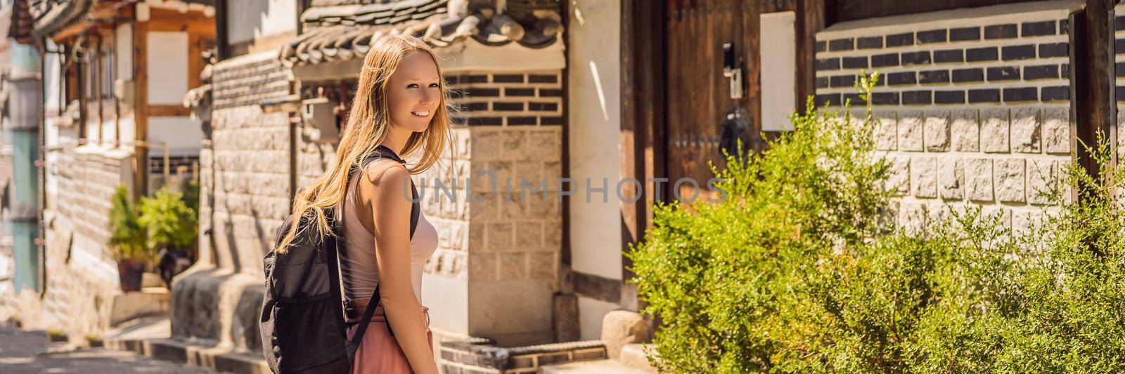 Young woman tourist in Bukchon Hanok Village is one of the famous place for Korean traditional houses have been preserved. Travel to Korea Concept. BANNER, LONG FORMAT