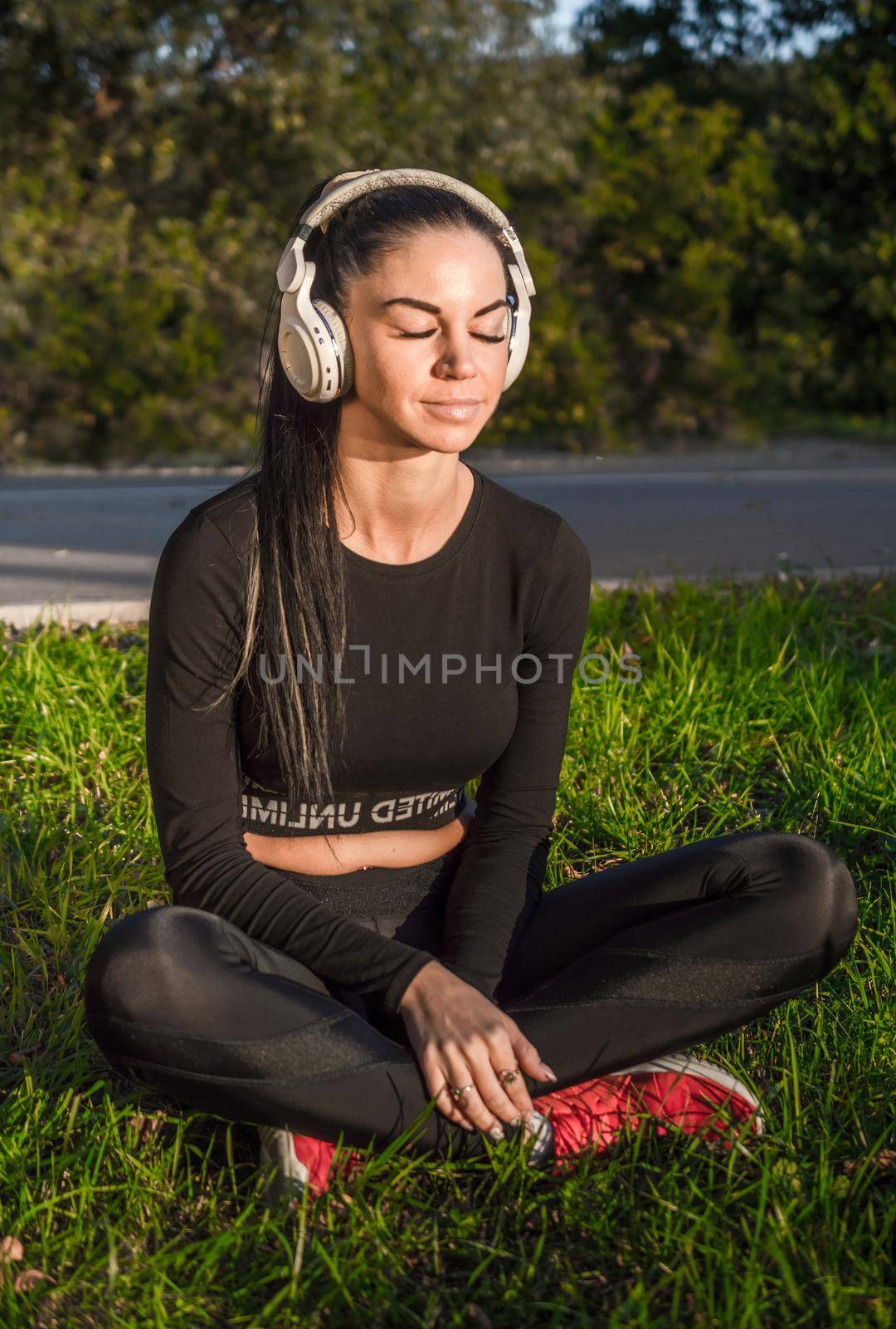 Beautiful young brunette woman and headphones listen music and smile./Nice sporty girl enjoying music with headphones.