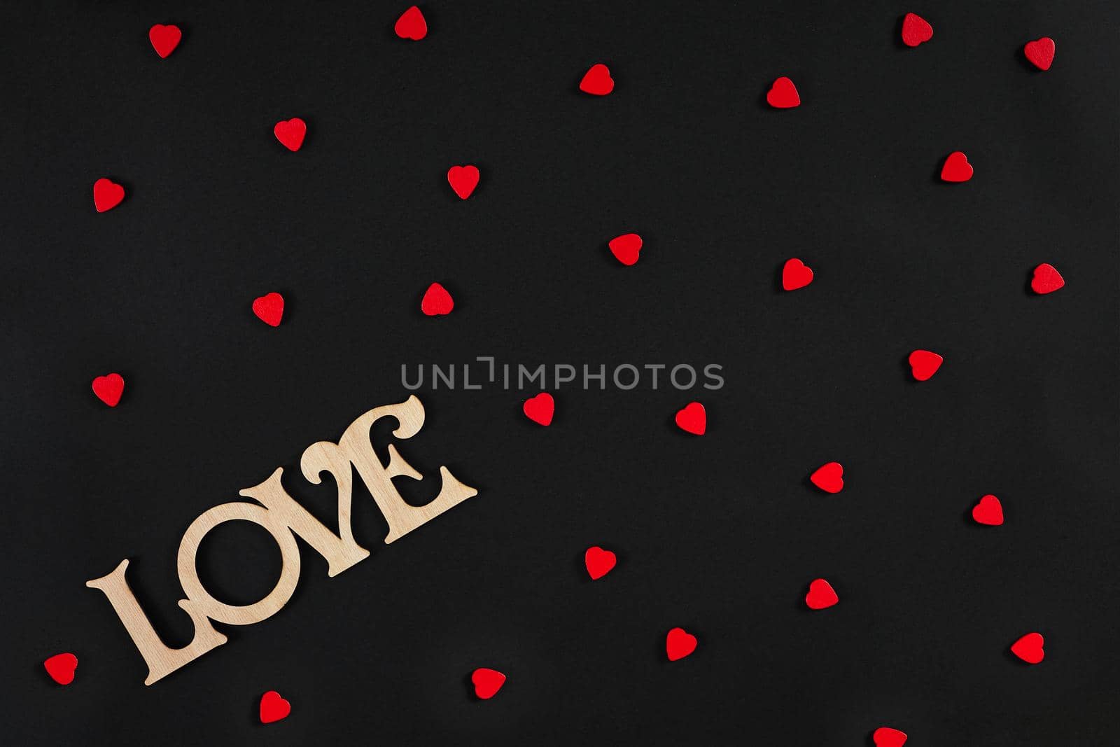 Valentines day background. Red hearts on the black desk. Top view. Copy space. Still life. Flat lay.