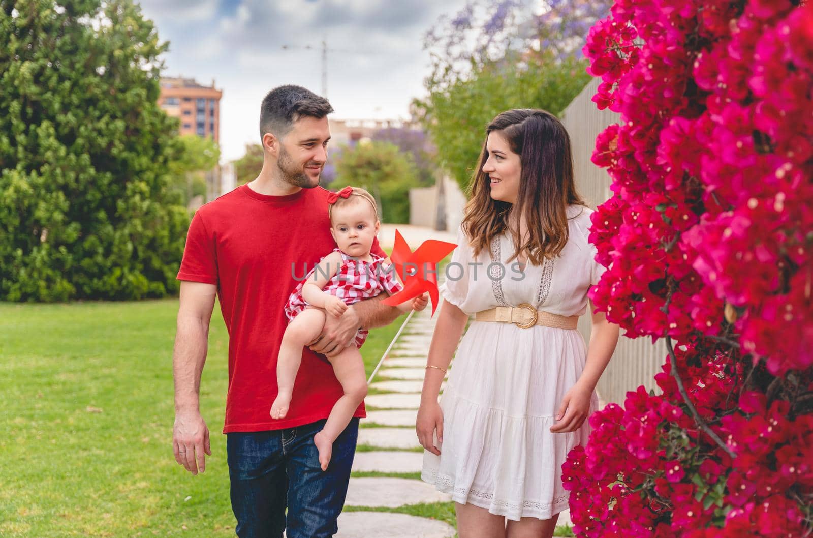 Happy family walking and laughing in the summer park. Portrait of a Caucasian mother and father with their children on a sunny summer day in the woods. Family lifestyle concept. high quality photo